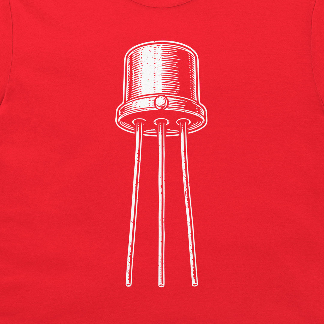A close-up of a bright red t-shirt, featuring a white hand-drawn style graphic of an electronic transistor component in the center.