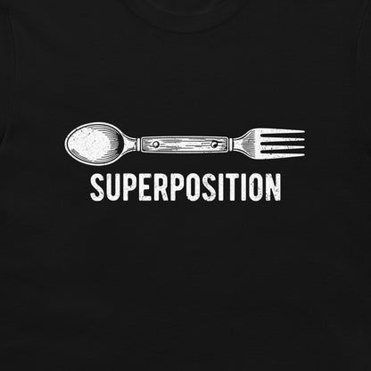 A close-up of a black t-shirt featuring a white graphic of a spoon fused with a fork, with the word 'SUPERPOSITION' printed below in a distressed white font.