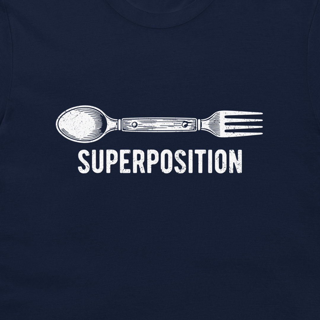 A close-up of a navy blue t-shirt featuring a white graphic of a spoon fused with a fork, with the word 'SUPERPOSITION' printed below in a distressed white font.