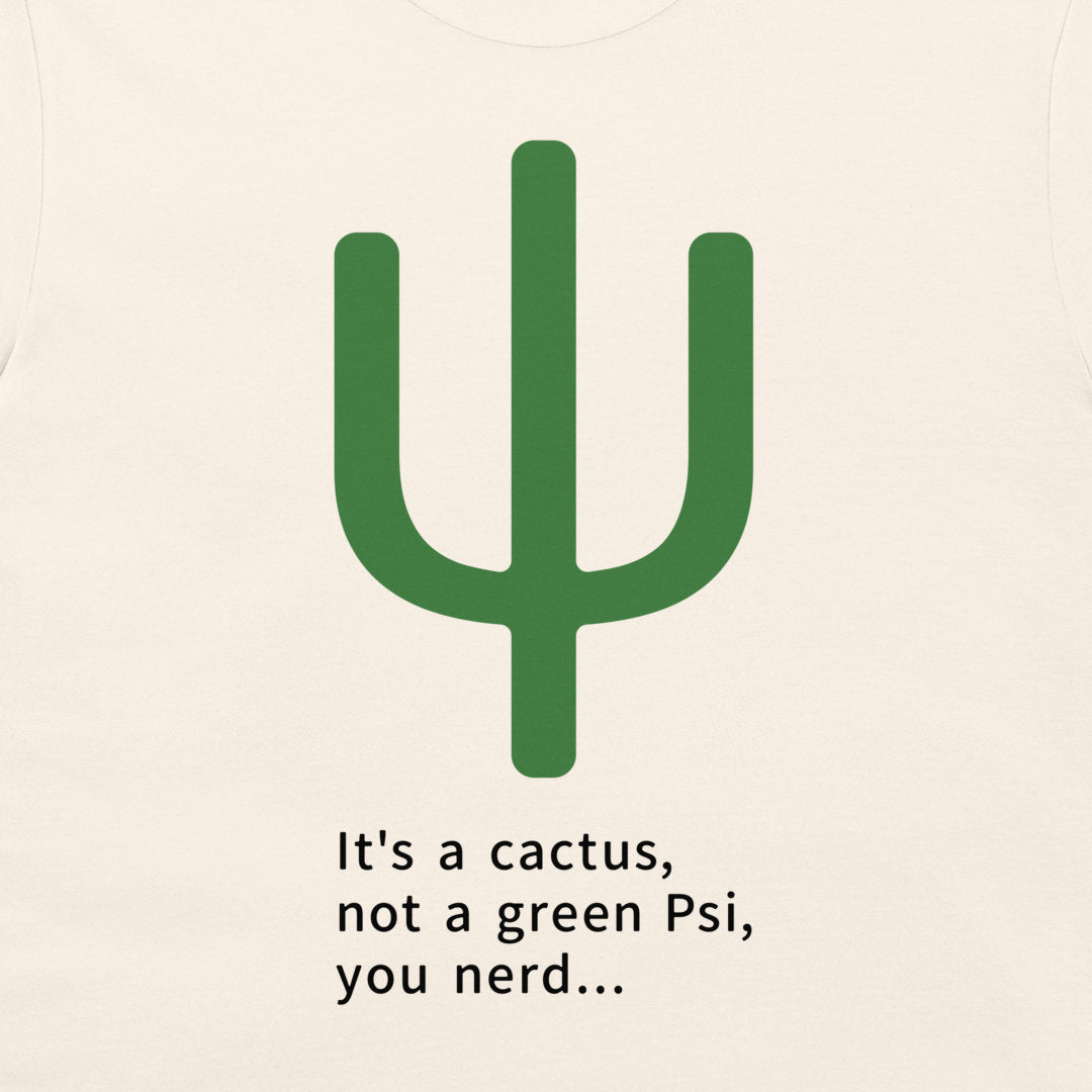 A close-up of a light cream-colored t-shirt featuring a green cactus graphic and the printed text 'It's a cactus, not a green Psi, you nerd.