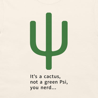 A close-up of a light cream-colored t-shirt featuring a green cactus graphic and the printed text 'It's a cactus, not a green Psi, you nerd.