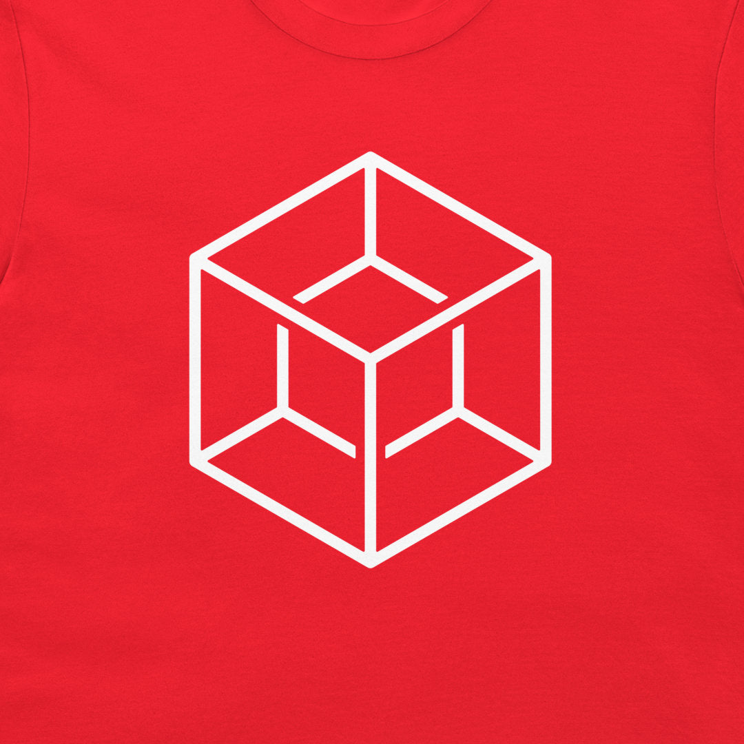 A close-up of a bright red t-shirt, featuring a white minimalist line art graphic of an isometric cube with a '3D illusion' in the center.