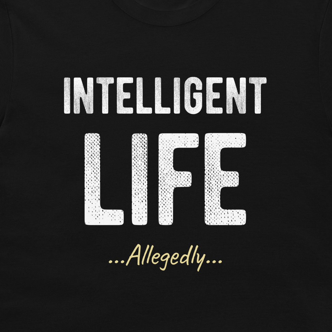 A close-up of a black t-shirt featuring a white graphic print that reads 'INTELLIGENT LIFE ...Allegedly...' in stylized fonts.