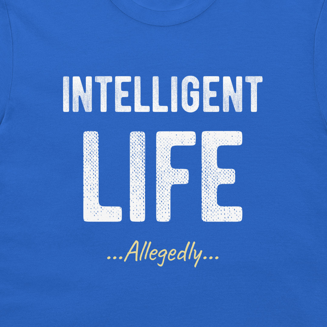 A close-up of a blue t-shirt featuring a white graphic print that reads 'INTELLIGENT LIFE ...Allegedly...' in stylized fonts.