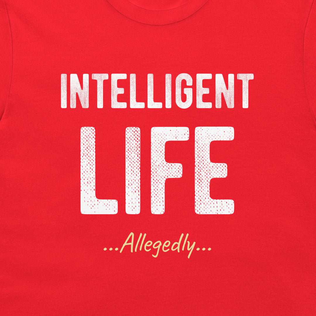 A close-up of a red t-shirt featuring a white graphic print that reads 'INTELLIGENT LIFE ...Allegedly...' in stylized fonts.