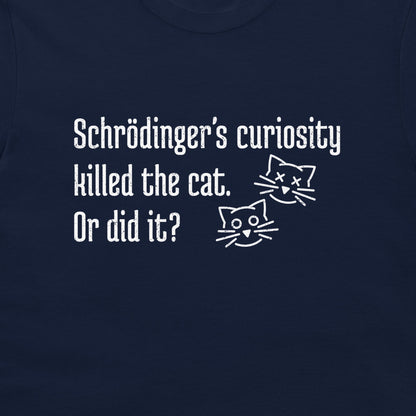 A close-up of a navy blue t-shirt featuring a white printed graphic with the text 'Schrödinger's curiosity killed the cat. Or did it?' and two simple line-art cat faces, one alive and one with X's for eyes.