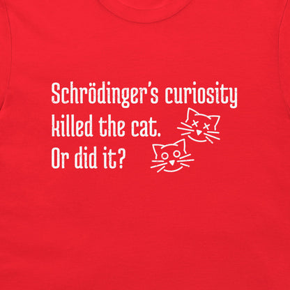 A close-up of a red t-shirt featuring a white graphic print with the text 'Schrödinger's curiosity killed the cat. Or did it?' and two simple line-art cat faces, dead and alive.