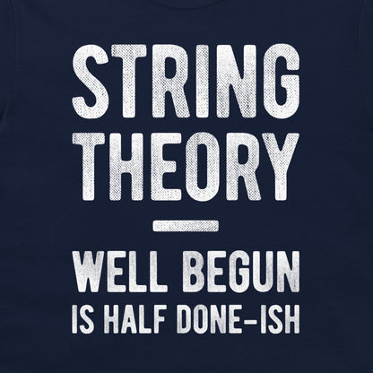 A close-up of a navy blue garment, likely a t-shirt, featuring a distressed white graphic print that reads 'STRING THEORY WELL BEGUN IS HALF DONE-ISH'.
