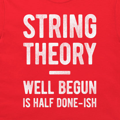A close-up of a red garment, likely a t-shirt, featuring a distressed white graphic print that reads 'STRING THEORY WELL BEGUN IS HALF DONE-ISH'.