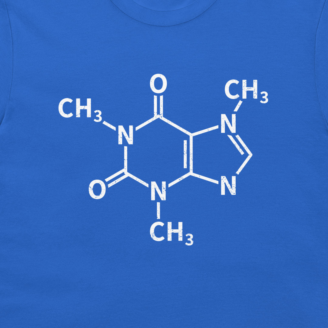 A close-up of a caffeine molecule structure graphic printed on a royal blue T-shirt