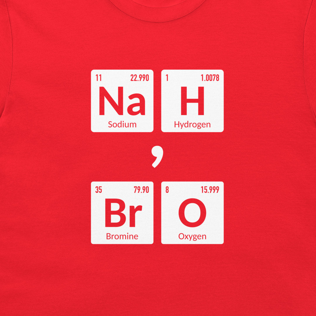 A close-up of a bright red t-shirt, featuring a graphic print of periodic table element tiles that spell out 'Na H Br O' separated by a semicolon.