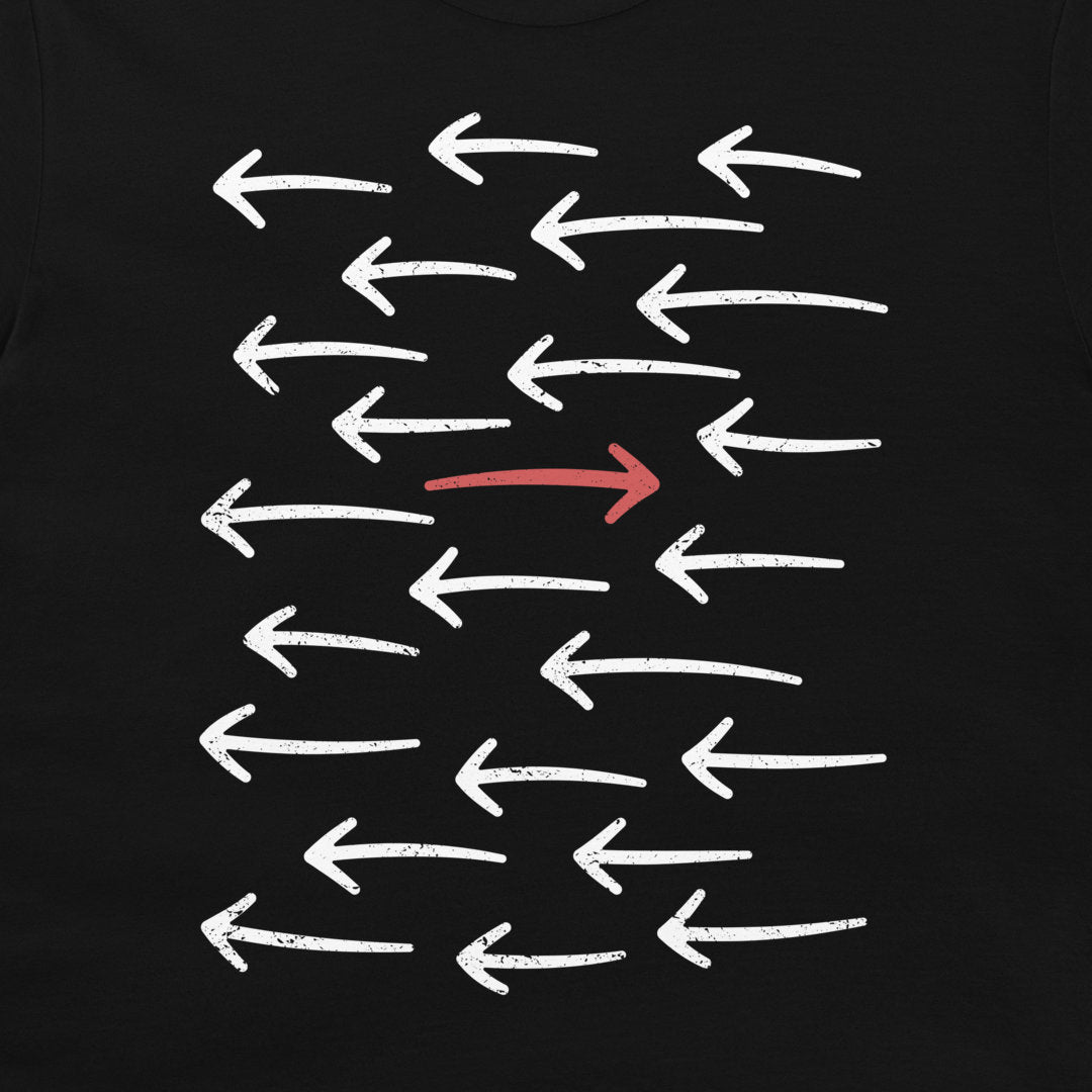 A black t-shirt featuring a graphic print of multiple white distressed arrows pointing left, with one central arrow pointing right in red.