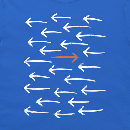 A close-up of a royal blue t-shirt featuring a graphic print of multiple white chalk-style arrows pointing left, with one prominent orange arrow pointing right in the center.