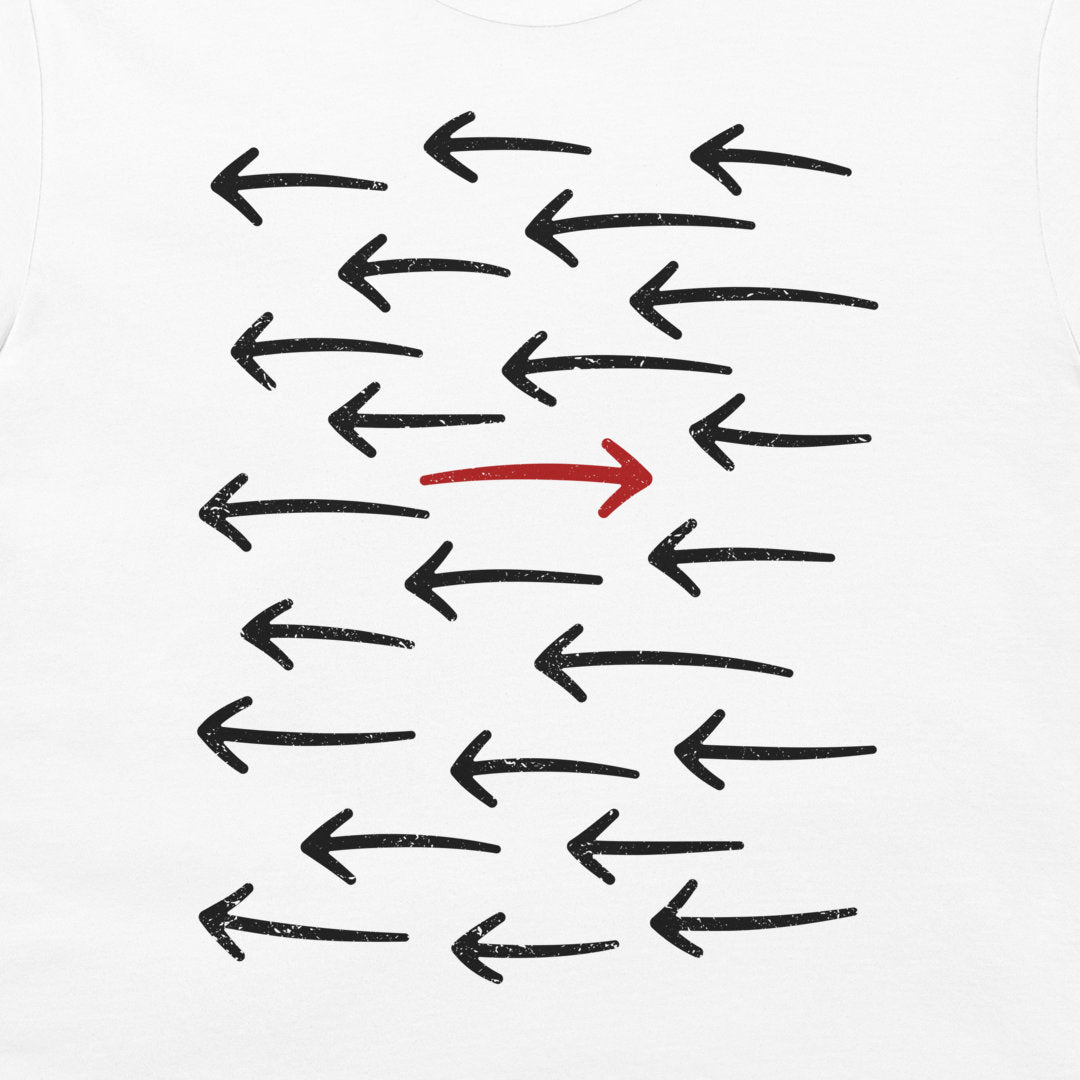 A white t-shirt featuring a graphic print of multiple black hand-drawn arrows pointing left, with one prominent red arrow pointing right in the center.