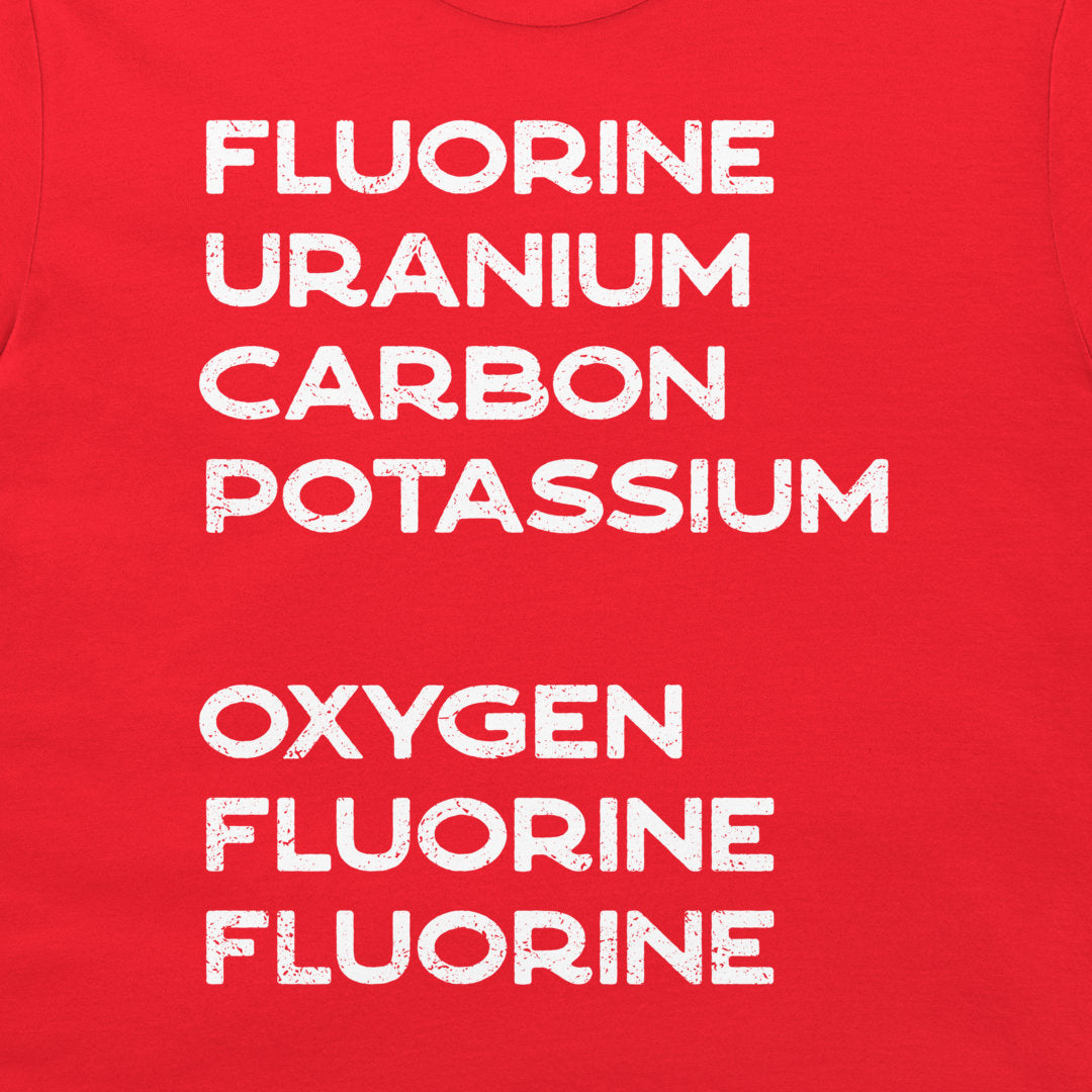 Close-up of a sarcastic chemistry word puzzle printed in white on a red T-shirt