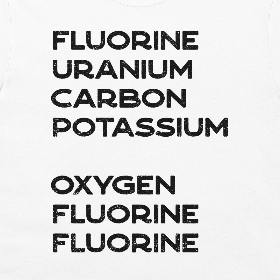 Close-up of black distressed element-name typography on a white science joke T-shirt