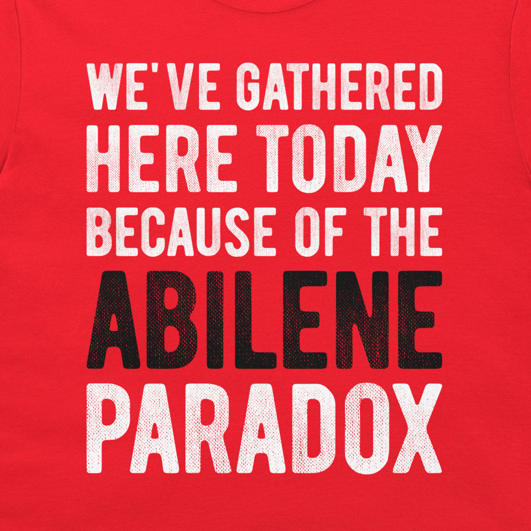 Close-up of Abilene Paradox organizational behavior joke printed on a red T-shirt