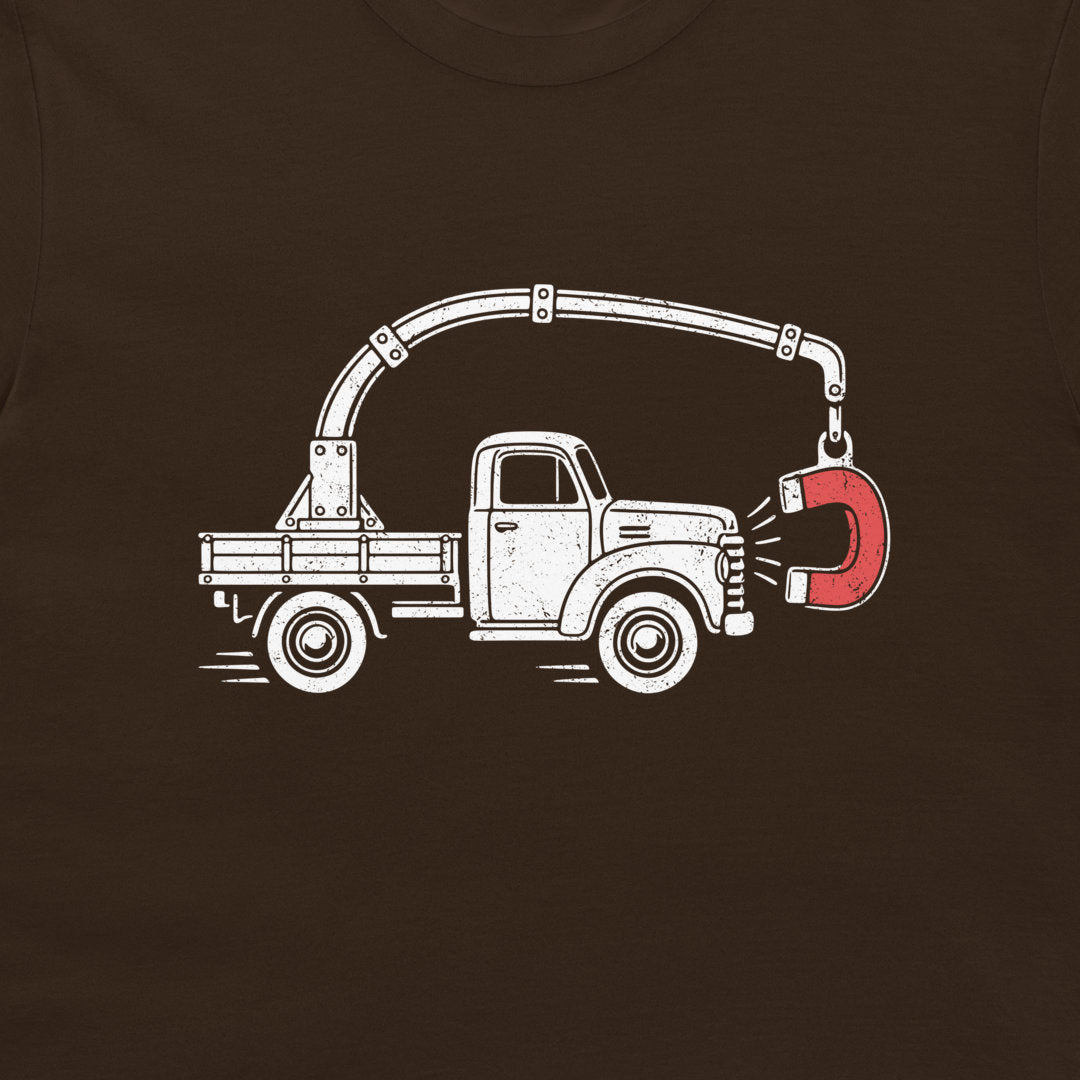 Close-up of the perpetual motion truck and red magnet graphic on a dark chocolate T-shirt