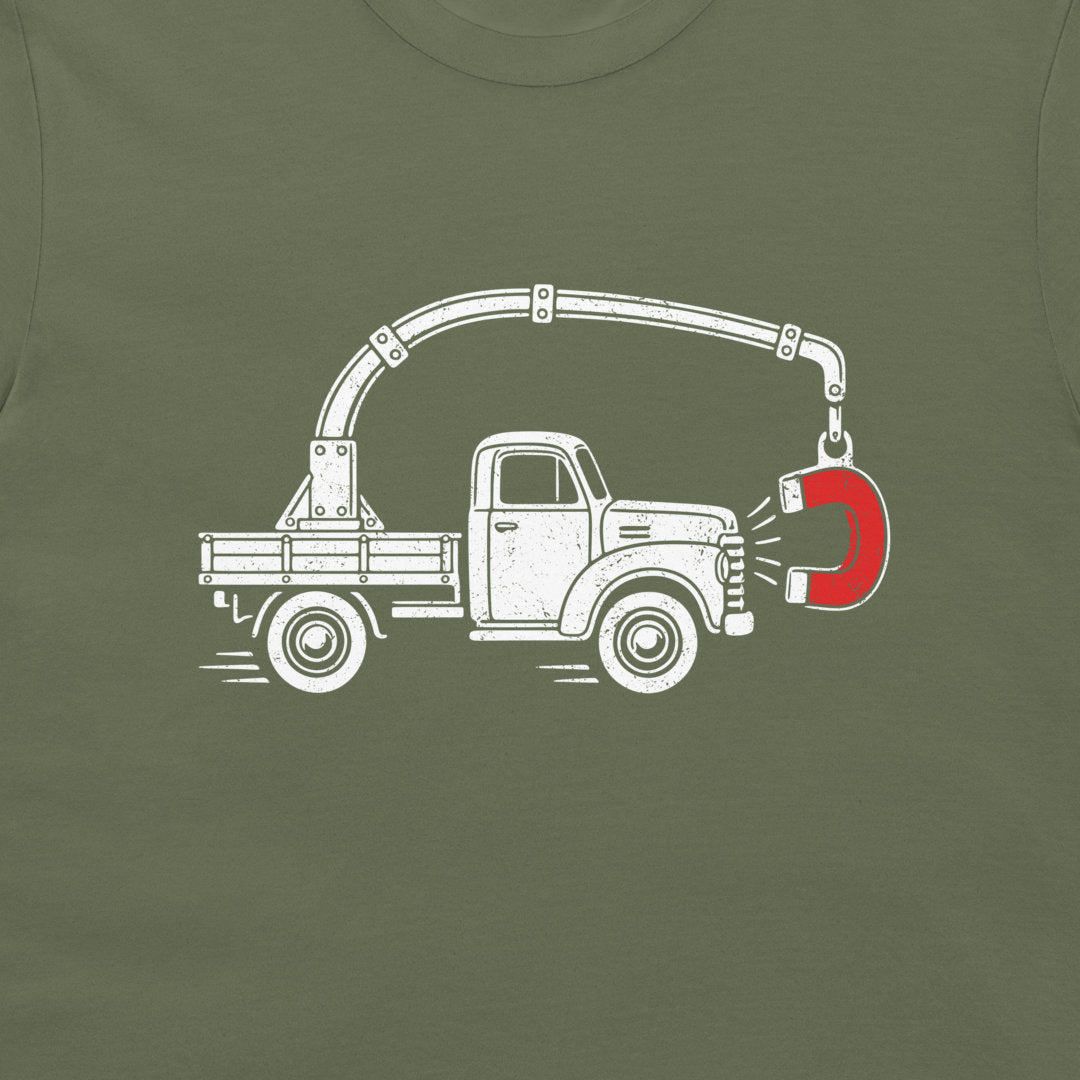 Close-up of the perpetual motion truck and red magnet graphic on a military green T-shirt