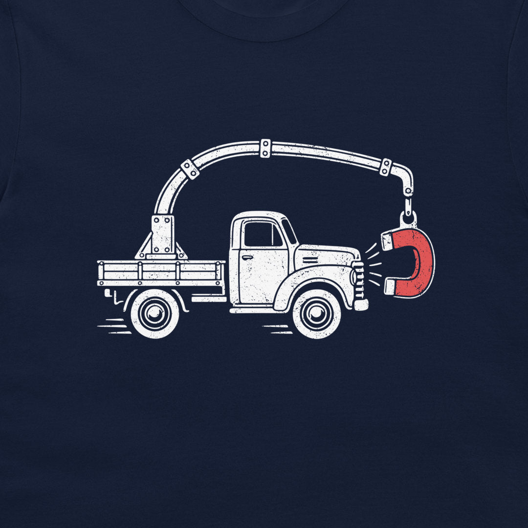 Close-up of the perpetual motion truck and red magnet graphic on a navy T-shirt