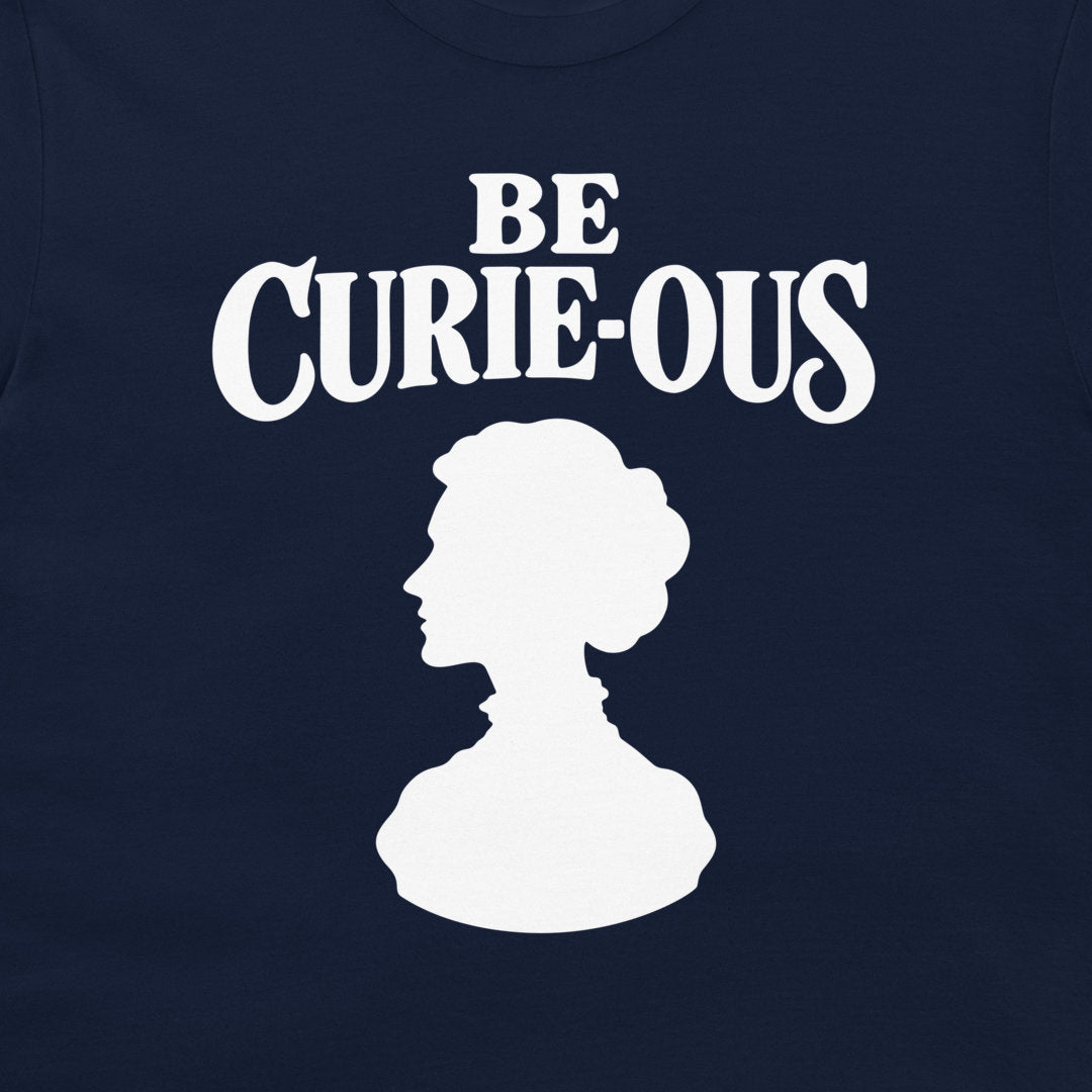 Close-up of the white Be Curie-ous design on a navy T-shirt.