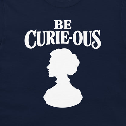 Close-up of the white Be Curie-ous design on a navy T-shirt.
