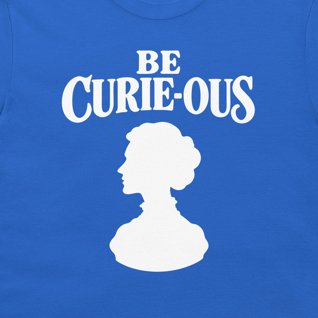 Close-up of the white Be Curie-ous design on a Royal Blue T-shirt.