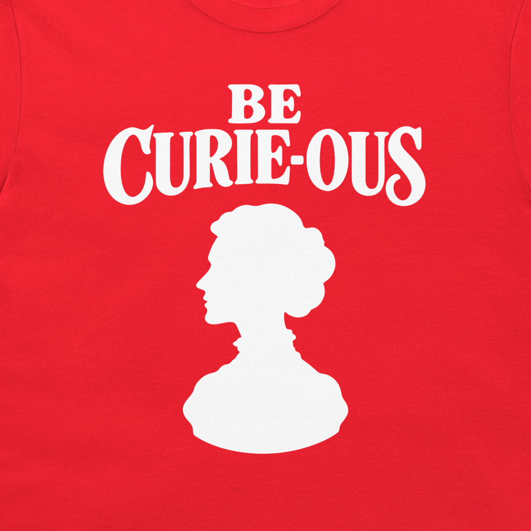 Close-up of the white Be Curie-ous design on a red T-shirt.
