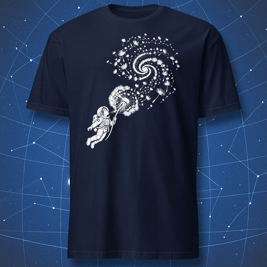 Navy T-shirt with an astronaut blowing a dandelion whose seeds form a spiral galaxy.