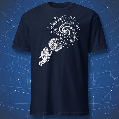Navy T-shirt with an astronaut blowing a dandelion whose seeds form a spiral galaxy.