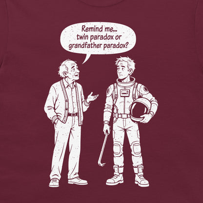 Close-up of the twin and grandfather paradox cartoon on a maroon T-shirt, with an old man and a traveler holding a crowbar.