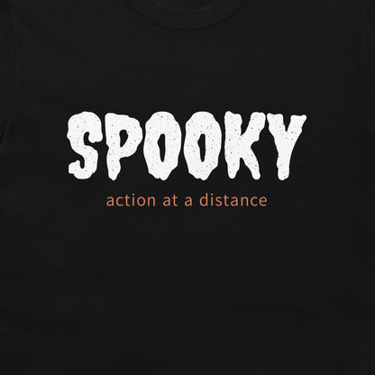Close-up of white SPOOKY lettering and orange action at a distance text on a black T-shirt.