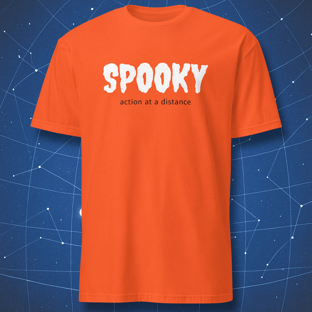 Orange T-shirt with white SPOOKY lettering and black action at a distance text on a blue background.