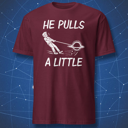 Maroon He Pulls a Little T-shirt with a white cartoon of a black hole pulling its owner along on a leash.
