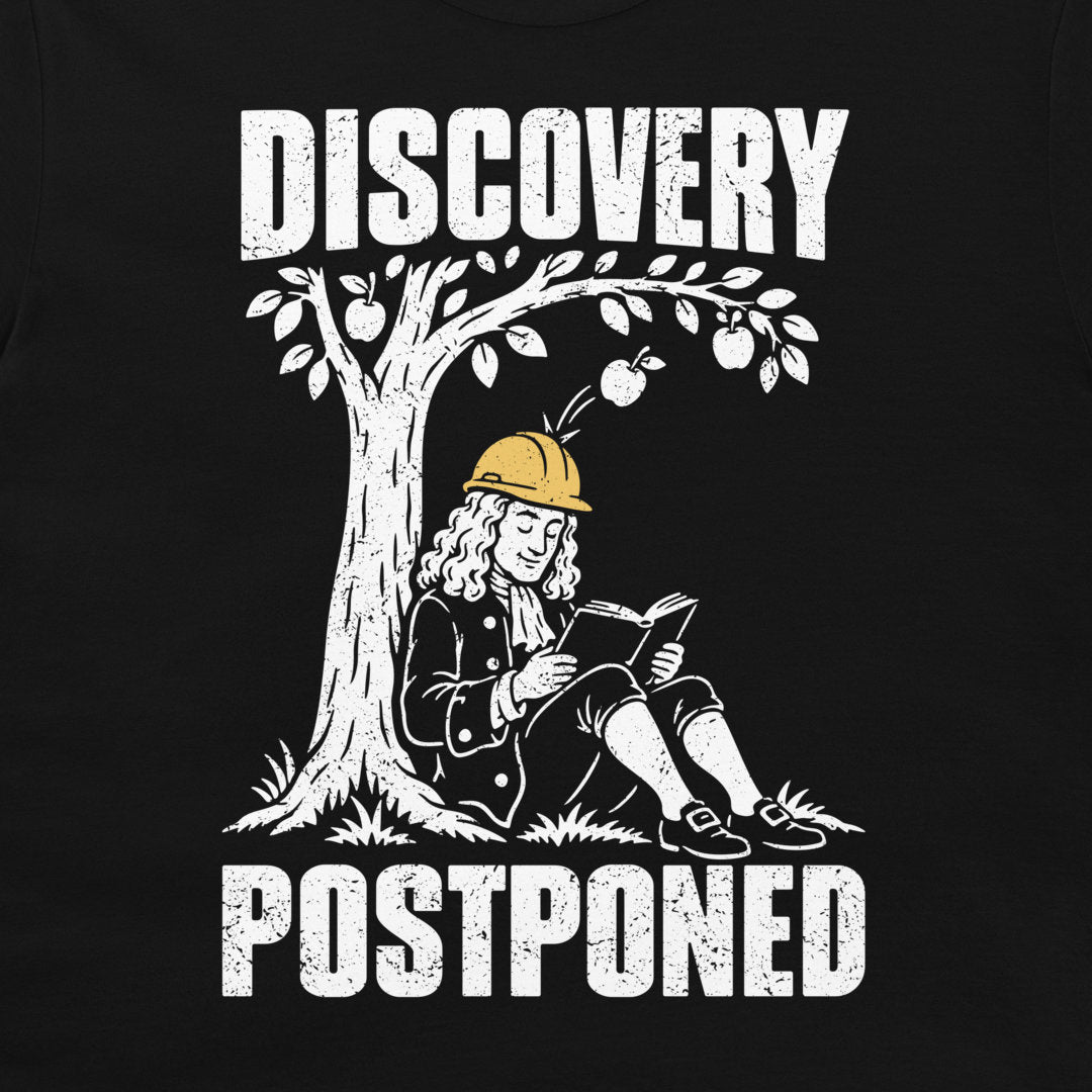 Close-up of Newton’s yellow hard hat deflecting an apple, framed by distressed white Discovery Postponed lettering on black fabric.
