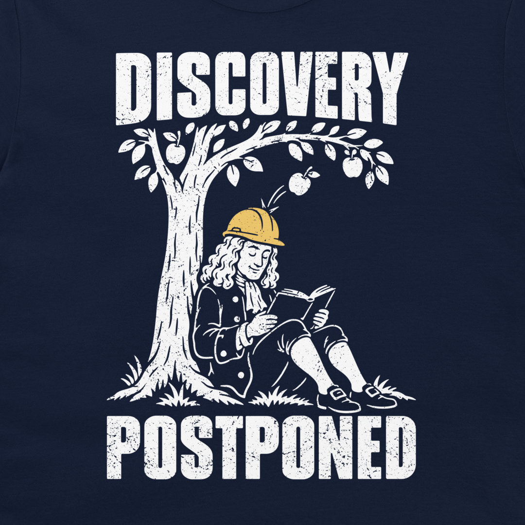 Detail of distressed white Discovery Postponed lettering and Newton reading in a yellow hard hat on navy fabric.