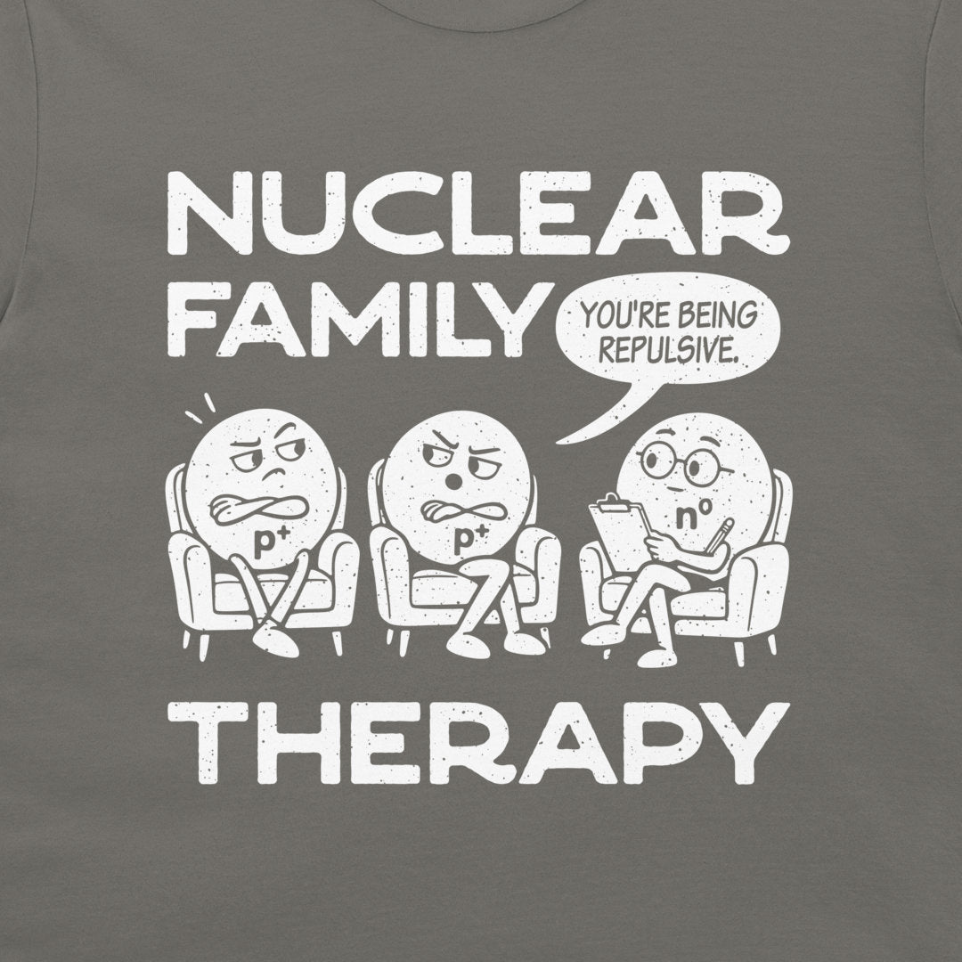 Close-up of the white Nuclear Family Therapy cartoon and You’re Being Repulsive speech bubble on charcoal fabric.