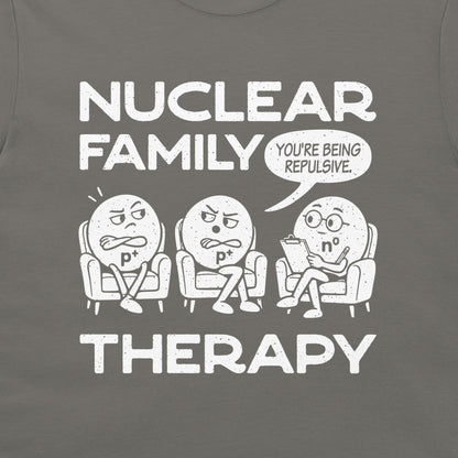 Close-up of the white Nuclear Family Therapy cartoon and You’re Being Repulsive speech bubble on charcoal fabric.