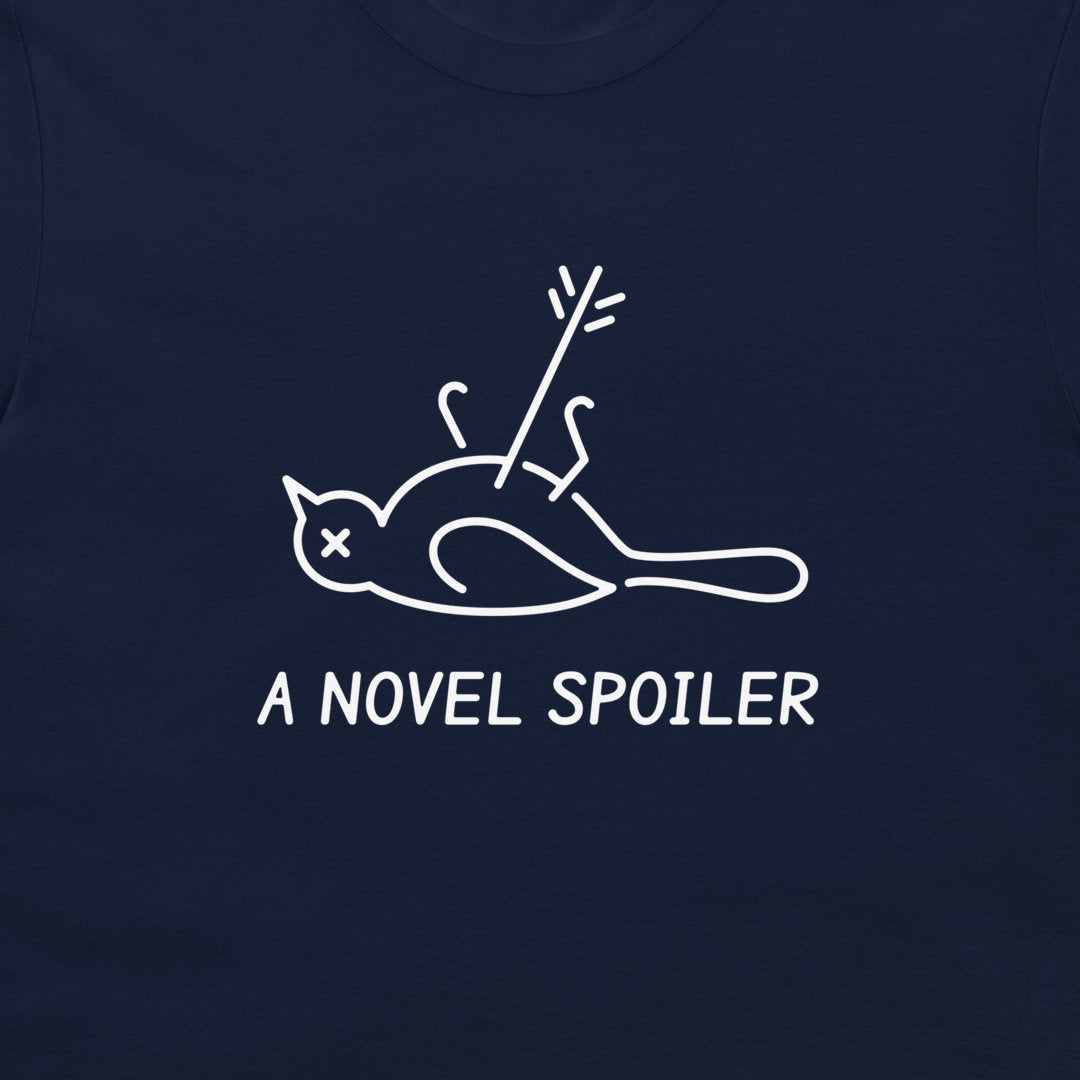 Close-up of the minimalist bird with an X eye, an arrow, and “A NOVEL SPOILER” lettering on navy fabric.