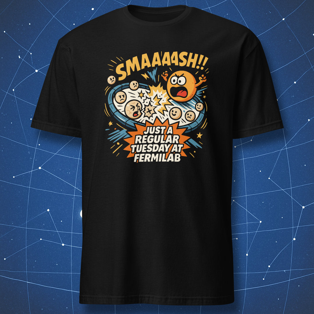 Black T-shirt with comic-style particle collision graphic and text “SMAAASH!! Just a regular Tuesday at Fermilab” — funny physics lab design.