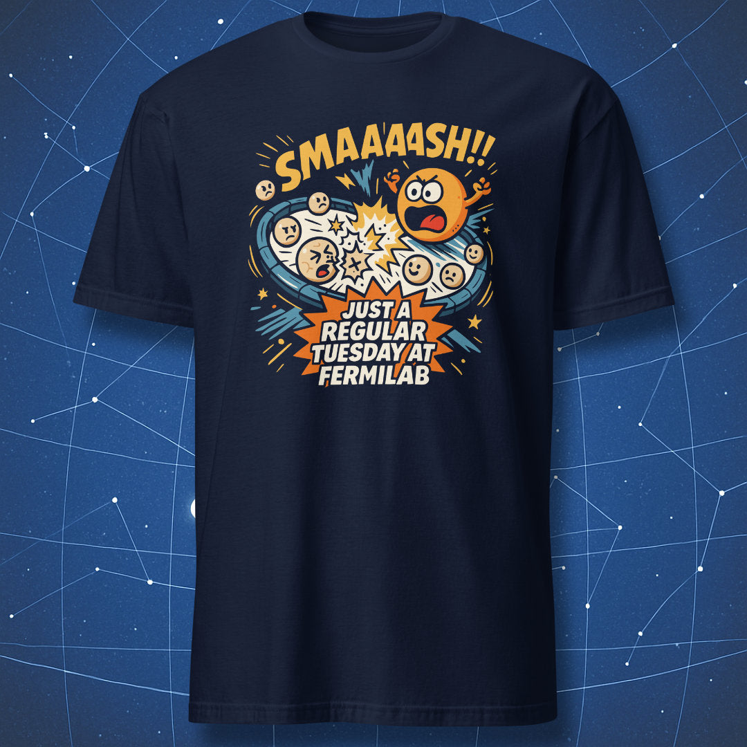 Navy T-shirt featuring colorful cartoon atoms colliding with “SMAAASH!! Just a regular Tuesday at Fermilab” — geeky particle physics humor tee.