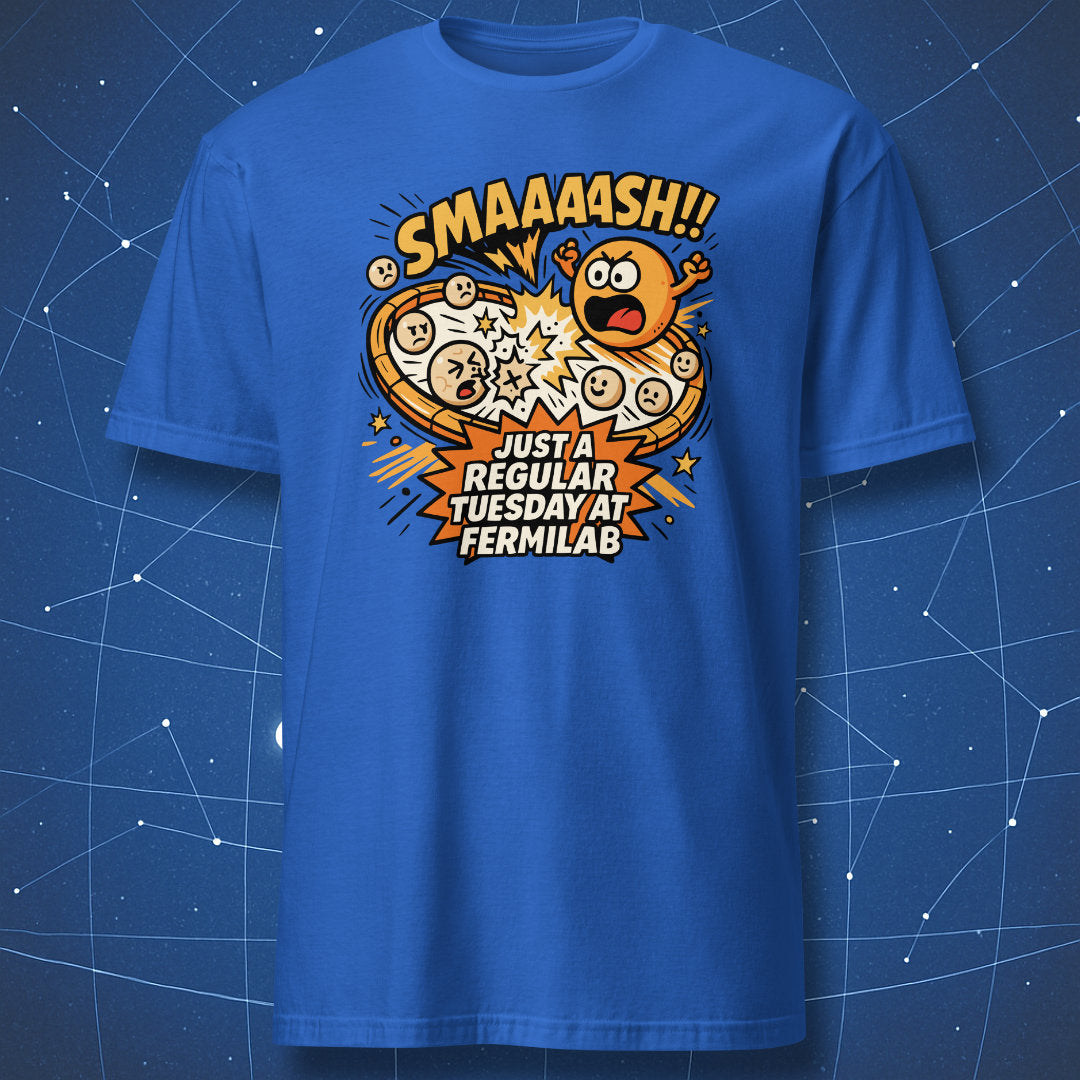 Royal blue T-shirt with energetic proton collision artwork and caption “SMAAASH!! Just a regular Tuesday at Fermilab” — science humor shirt.