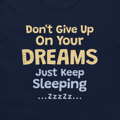 Close-up of the sarcastic dreams and sleeping quote design printed on a navy T-shirt.