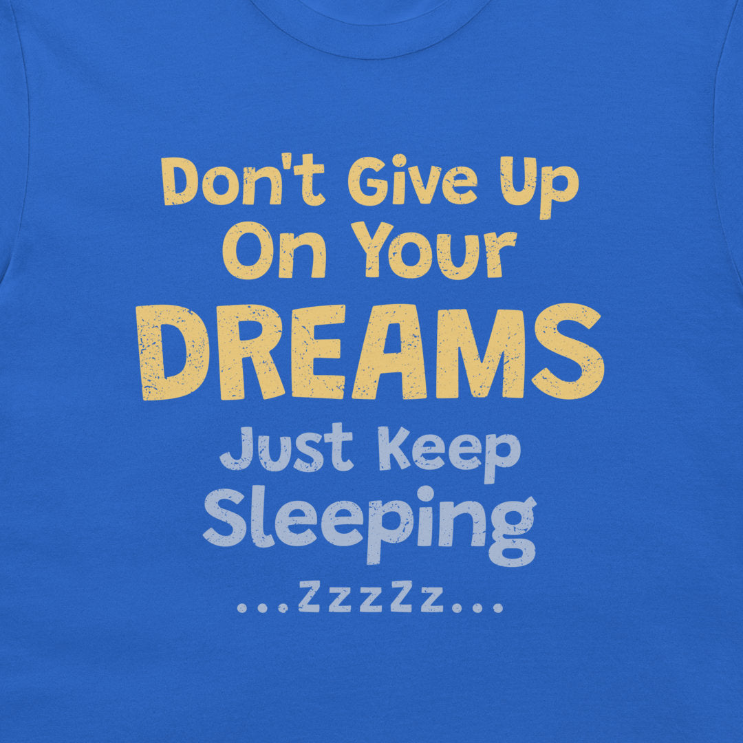 Close-up of the funny sleeping quote design in yellow and light blue on a royal blue T-shirt.