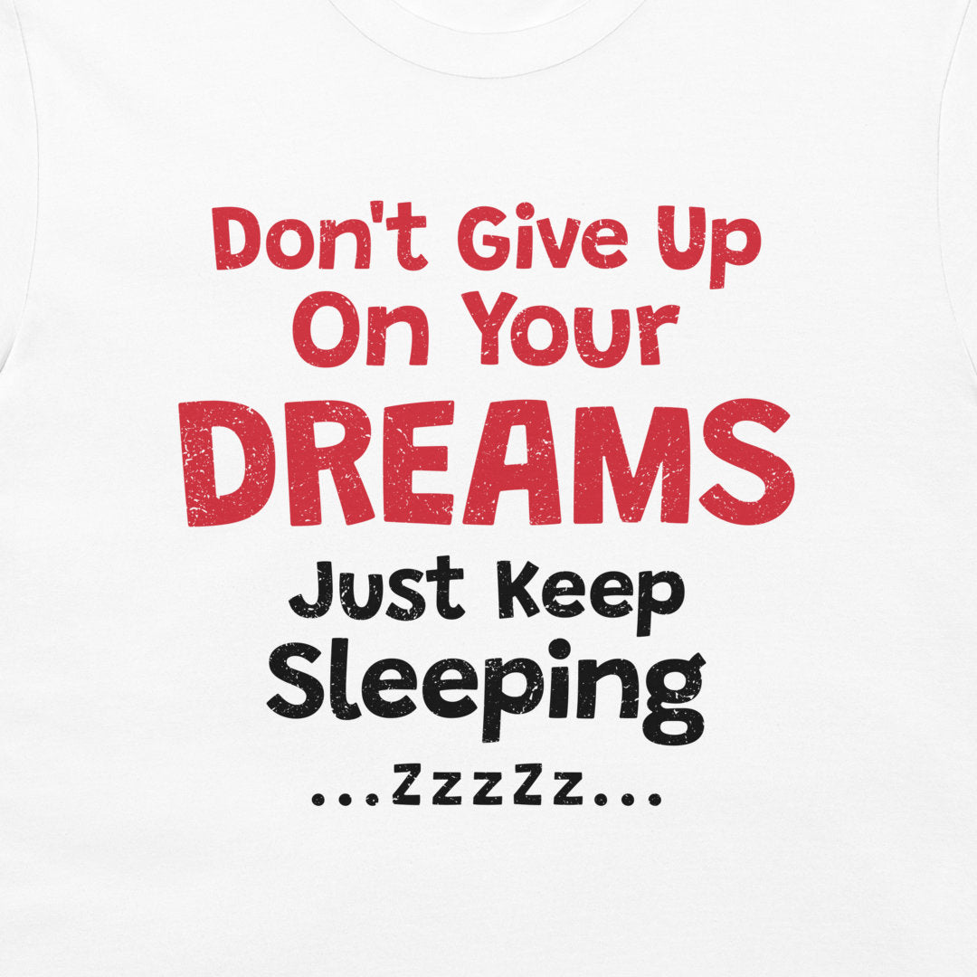Close-up of the sarcastic “Don't Give Up On Your Dreams – Just Keep Sleeping” design on white.
