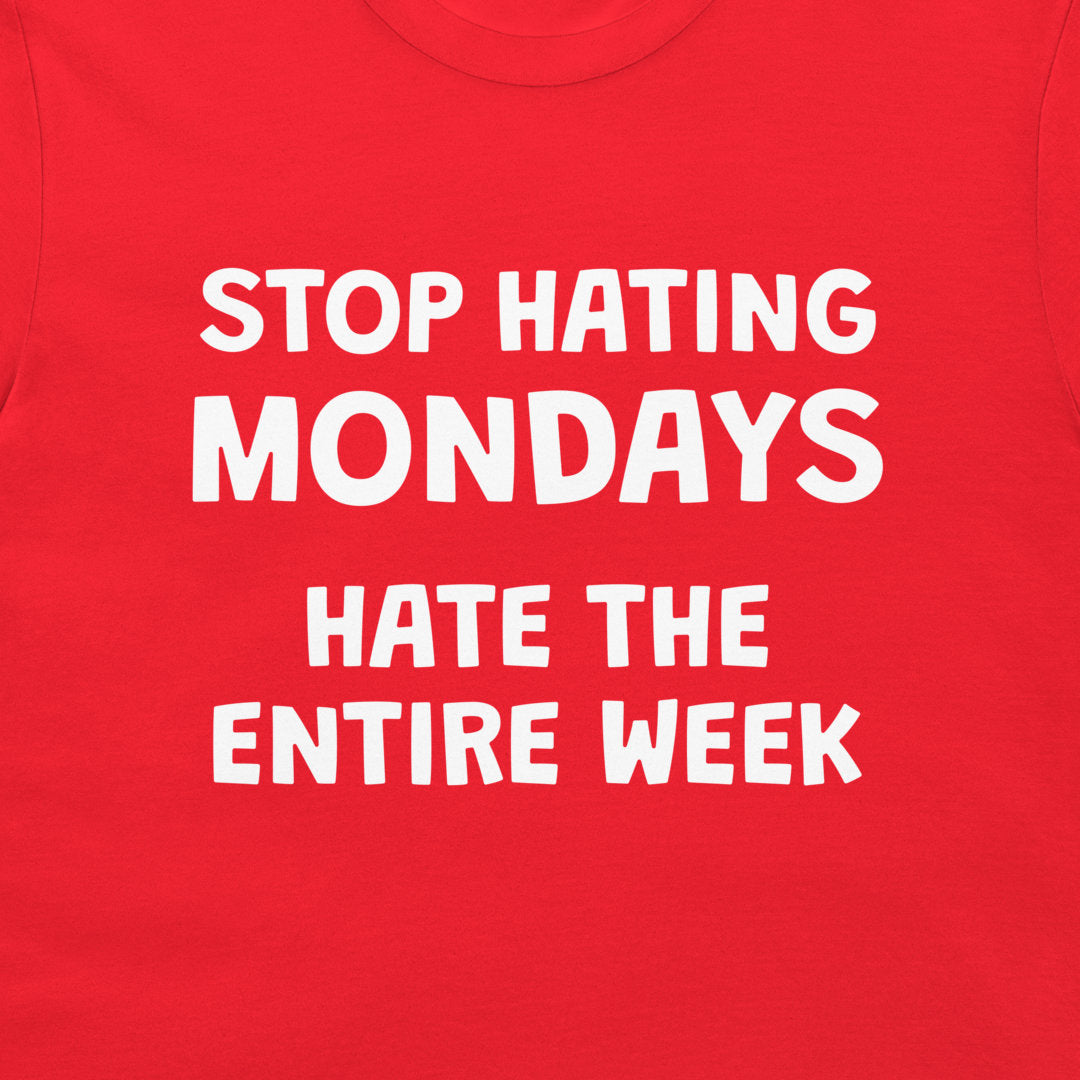 Close-up of sarcastic Stop Hating Mondays design printed on red T-shirt