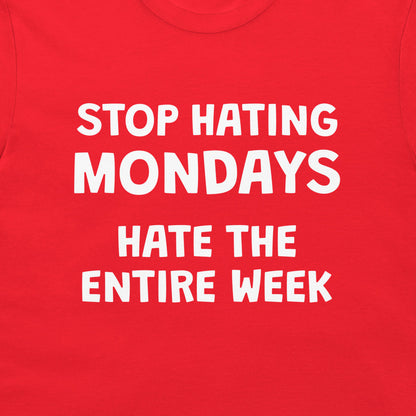 Close-up of sarcastic Stop Hating Mondays design printed on red T-shirt